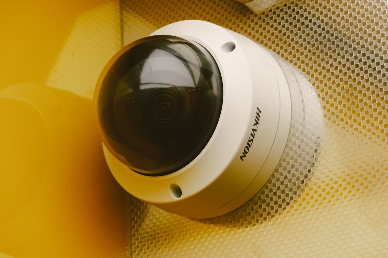 why-choose-us Close-up of a modern security camera installed indoors, ideal for surveillance.